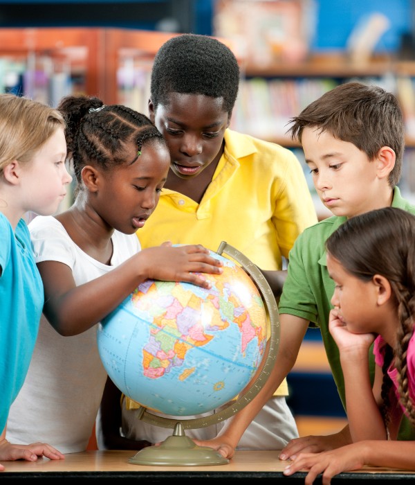 Students looking at globe